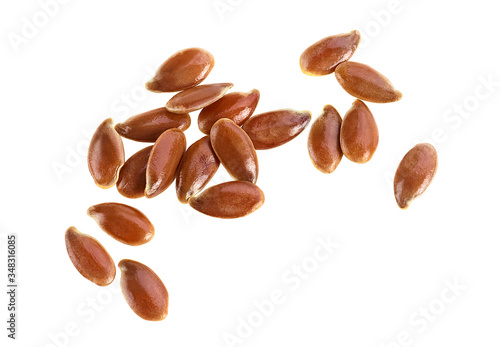 Close up of brown flax seeds isolated on a white background. Linum usitatissimum.