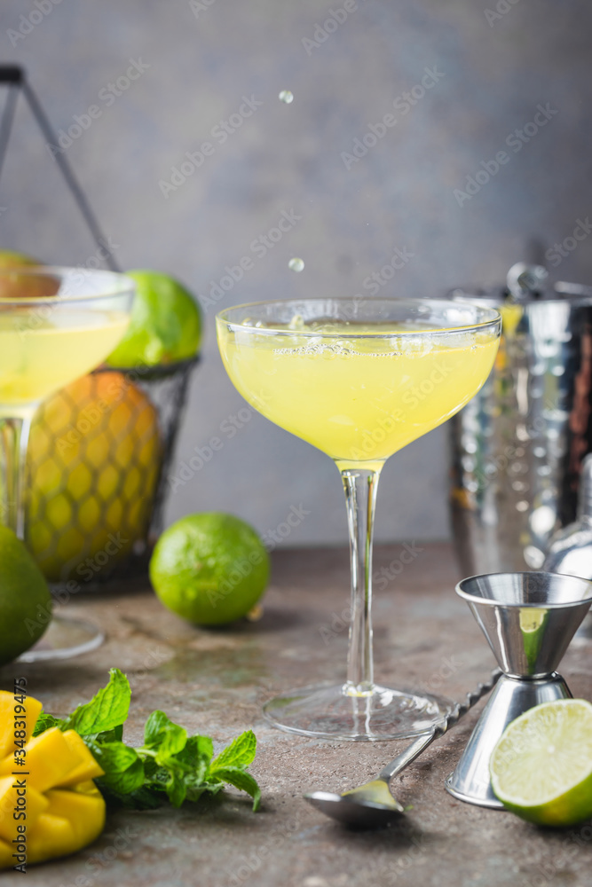 Margarita Mango alcoholic cocktail in a glass on stone background. Margarita Mango alcoholic cocktail in a glass on stone background.