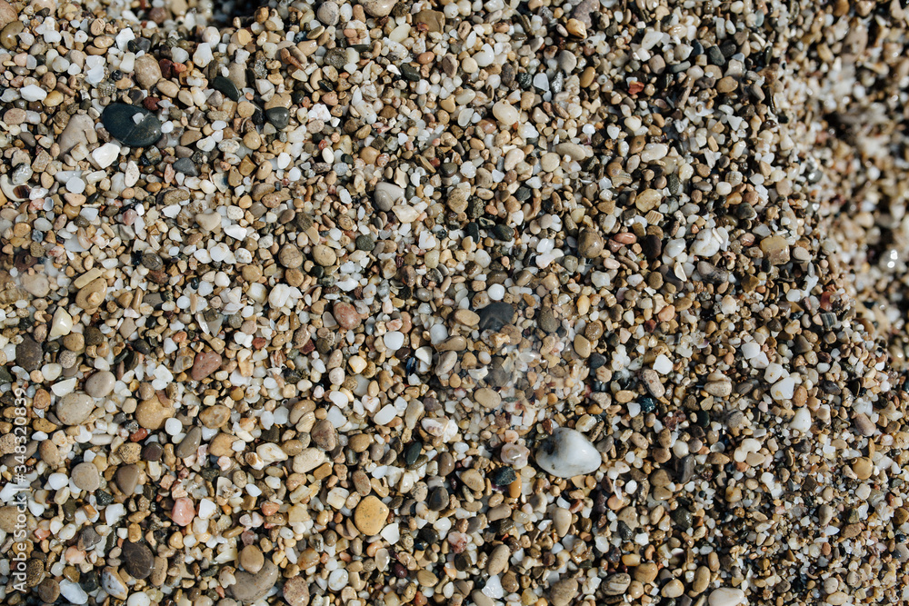 A lot of wet small stones on the beach. A lot of wet small stones on the beach.