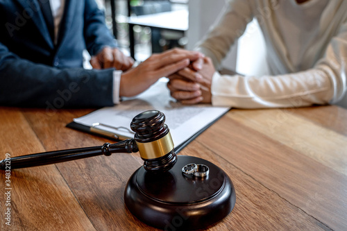 Contract decree of divorce (dissolution or cancellation) of marriage, husband and wife during divorce process and signing of divorce contract, Wedding ring