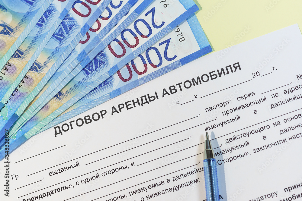 Obraz premium The signing of a bilateral agreement of renting a car from an individual. Russian roubles, the handle and the text 
