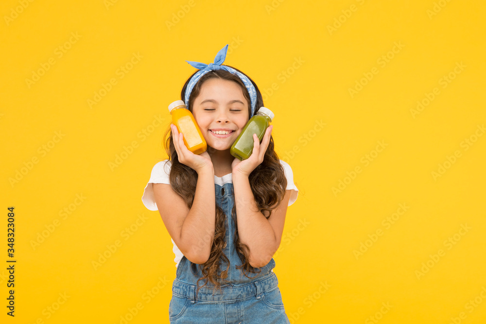 Fresh smoothie. Girl drinking orange fresh juice smoothie. Vegetarian concept. Hand crafted smoothie recipe. Fruit energy. Smiling kid hold smoothie bottles. Healthy food. Vitamin nutrition