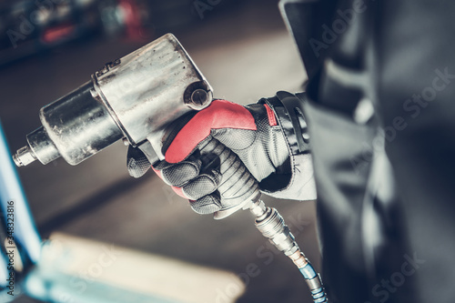 Mechanic Holding Pneumatic Wrench Gun.