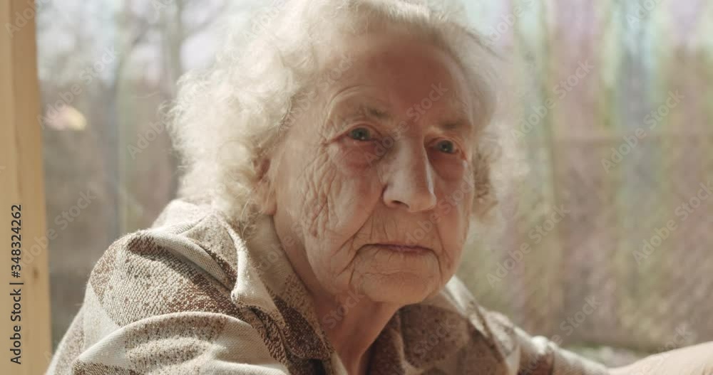 Elderly senior woman stay at home on quarantine. Pensive looking away and feel upset. Sad grandmother alone. Elderly senior woman stay at home on quarantine. Pensive looking away and feel upset. Sad grandmother alone.