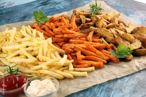 Variety of potatoes with fries. potato wedges, french fries, sweet potato for lunch on table