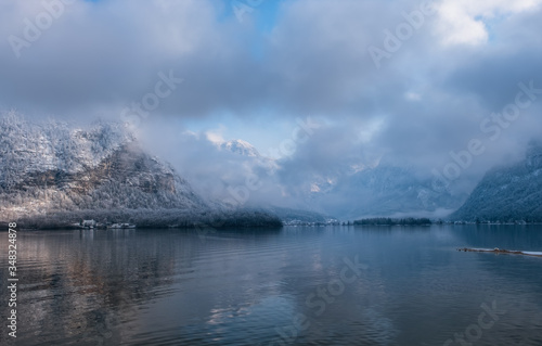 anorama view of Hallstattersee lake and mountain in daylight with snow. Landscape view of famous Hallstatt lakeside town during winter. Town square in Hallstat. Salzkammergut region, Austria. Jan2020