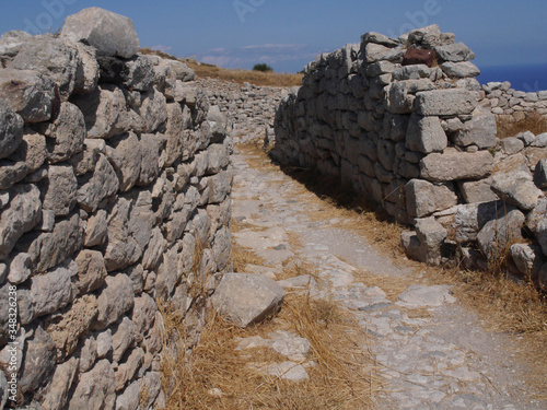 Ancient Thira (Thera) is an ancient city located on the steep rocky cape Mesa Vouno on Santorini island, Greece. The ruins of ancient buildings. photo