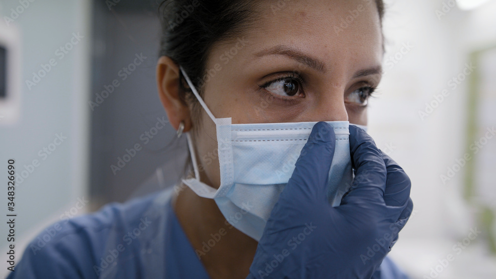 Nurse correcting mask for protection against covid-19 Nurse correcting mask for protection against covid-19
