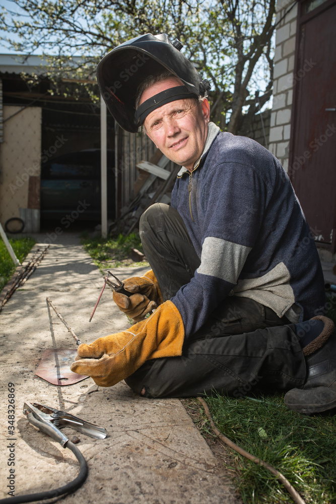 Welder is engaged in electric welding Welder is engaged in electric welding