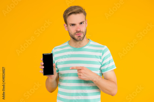 Download and start play. Man pointing at smartphone. Pointing gesture. Index finger pointing. Pointing for advertising. Digital technology. Mobile services. Free internet. Application smartphone