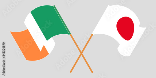 Crossed and waving flags of Ireland and Japan