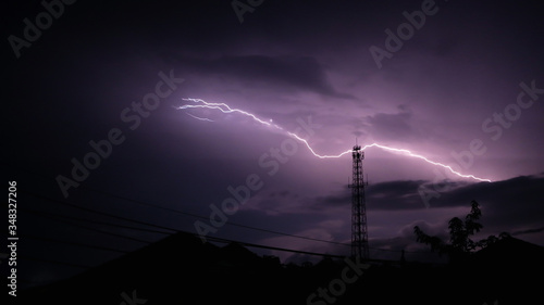 Real lightning bolt striked on the top of antenna tower in Trang Thailand at night