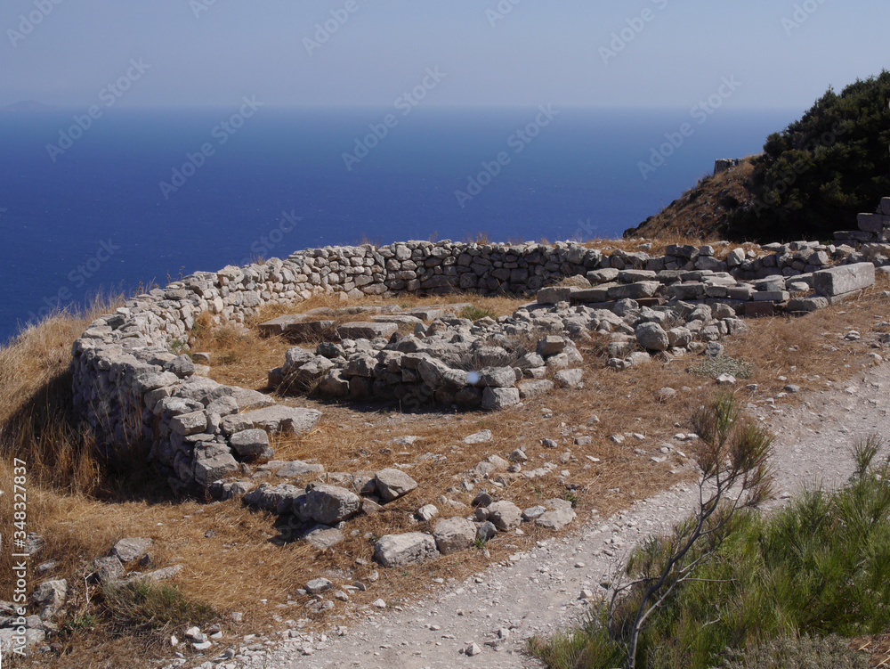 Ancient Thira (Thera) is an ancient city located on the steep rocky cape Mesa Vouno on Santorini island, Greece. The ruins of ancient buildings.