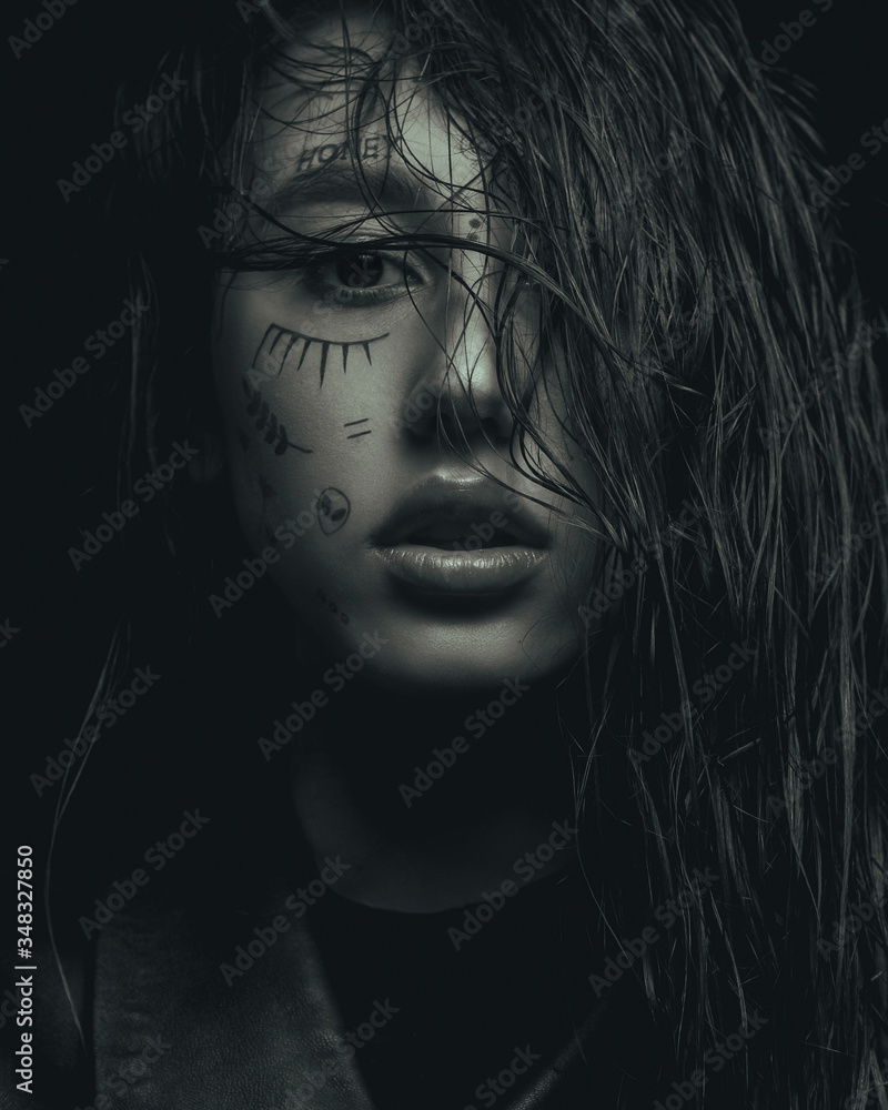 monochrome fashion portrait of a young girl, with drawings on her face monochrome fashion portrait of a young girl, with drawings on her face