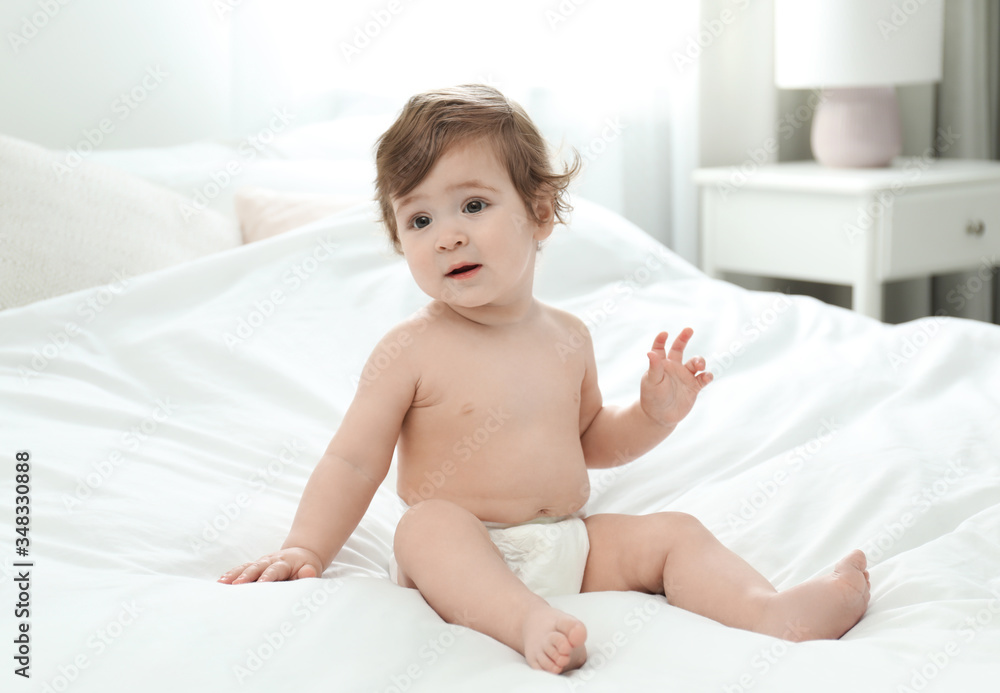 Cute little baby in diaper on bed Cute little baby in diaper on bed