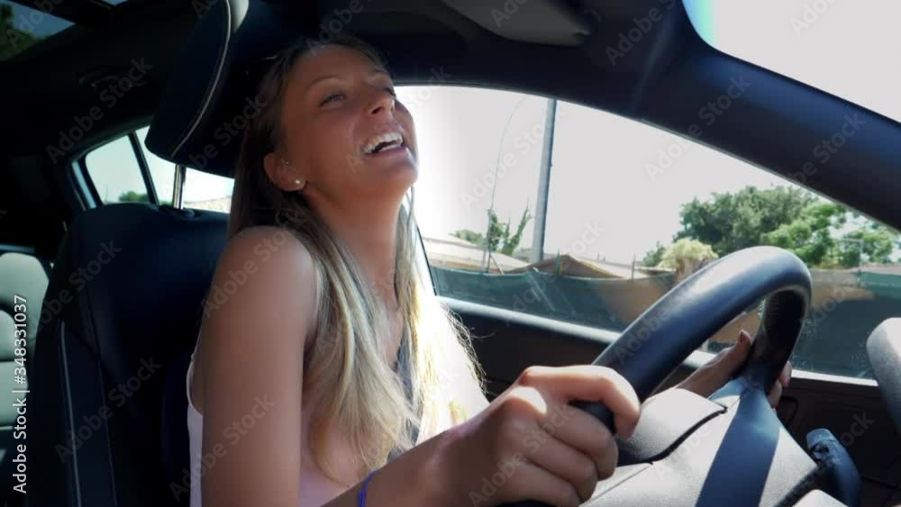 Girl full of joy feeling freedom after end of quarantine driving car listening music singing slow motion Girl full of joy feeling freedom after end of quarantine driving car listening music singing slow motion