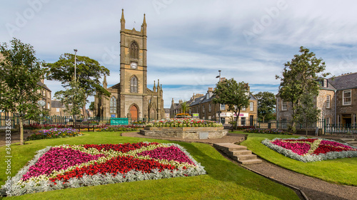 floral display in public gardens with a church as a backdrop