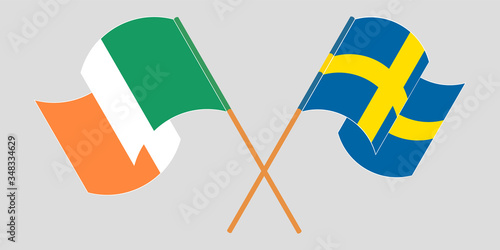 Crossed and waving flags of Ireland and Sweden