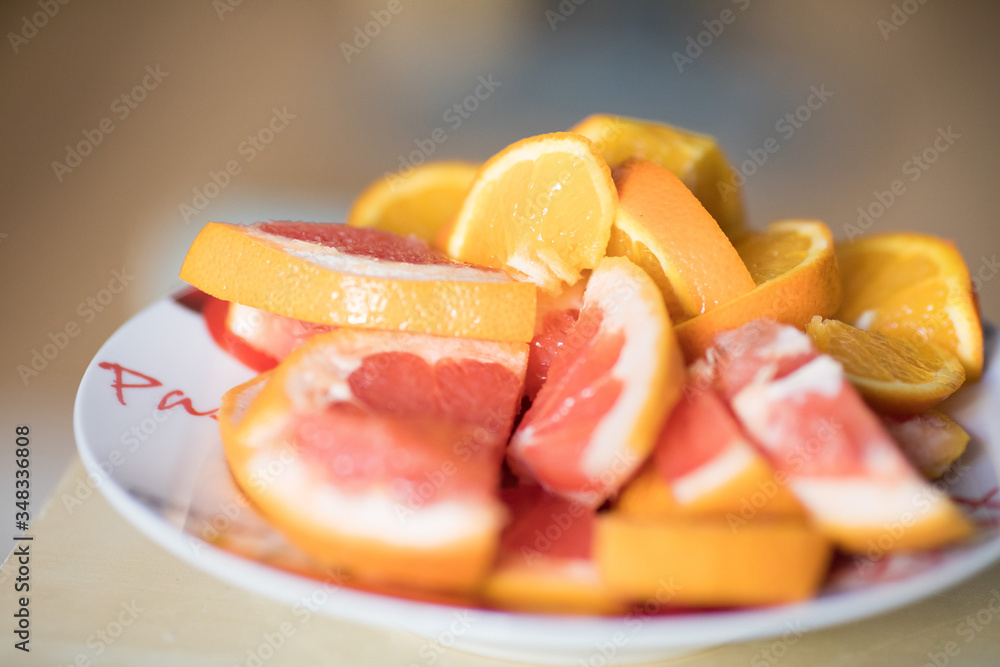 Orange and grapefruit in a plate. Slices of orange. Slices of grapefruit. Orange. Lobules. Plate. Tasty. Summer Orange and grapefruit in a plate. Slices of orange. Slices of grapefruit. Orange. Lobules. Plate. Tasty. Summer