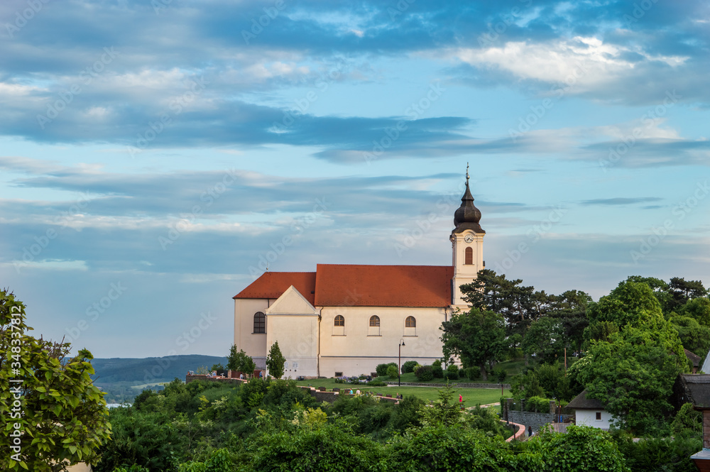 The century-old building of the Tihany abbey photographed from the side at sunset in a colorful summer environment