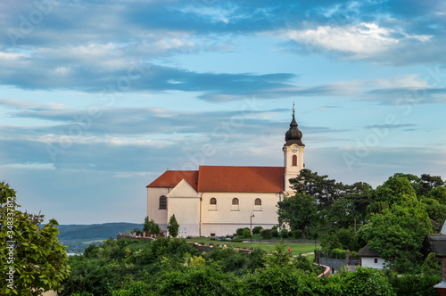 The century-old building of the Tihany abbey photographed from the side at sunset in a colorful summer environment