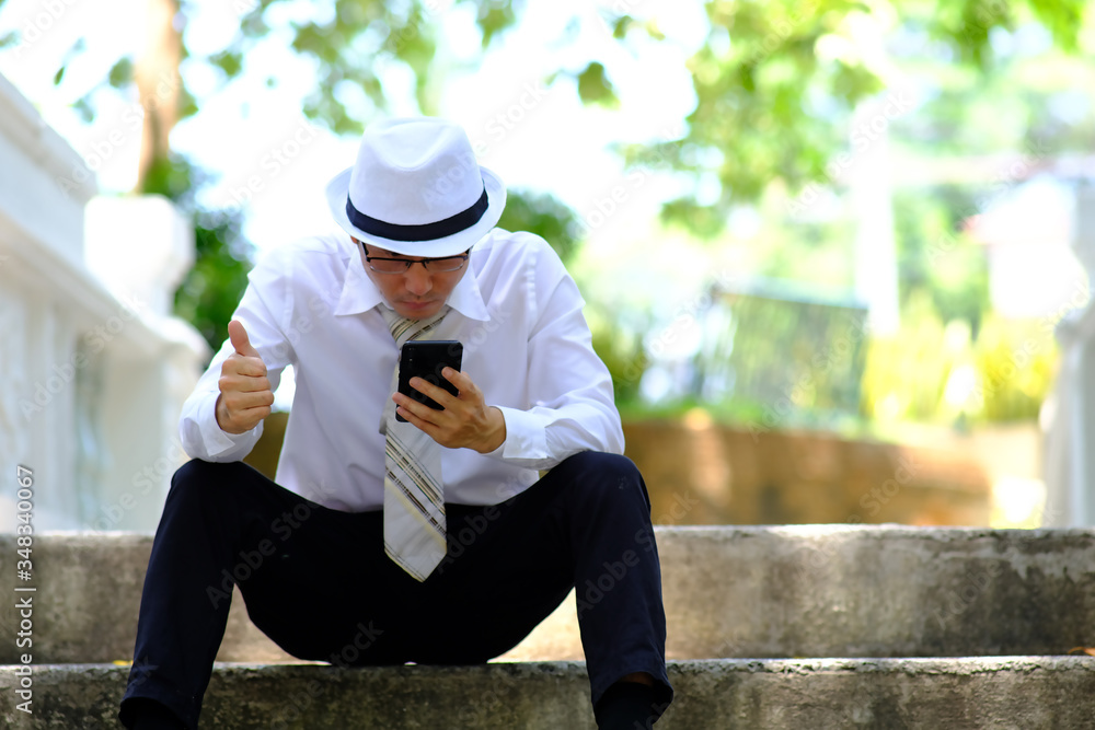 businessman using smartphone in the park and checking social networks, reading business news businessman using smartphone in the park and checking social networks, reading business news