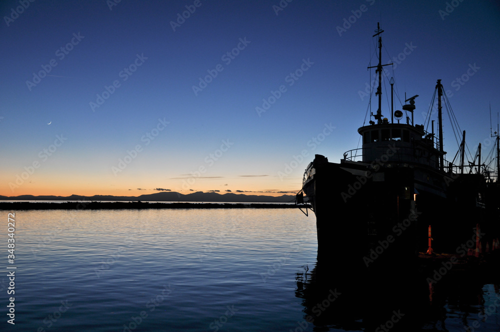 silhouette of a ship in the sunset