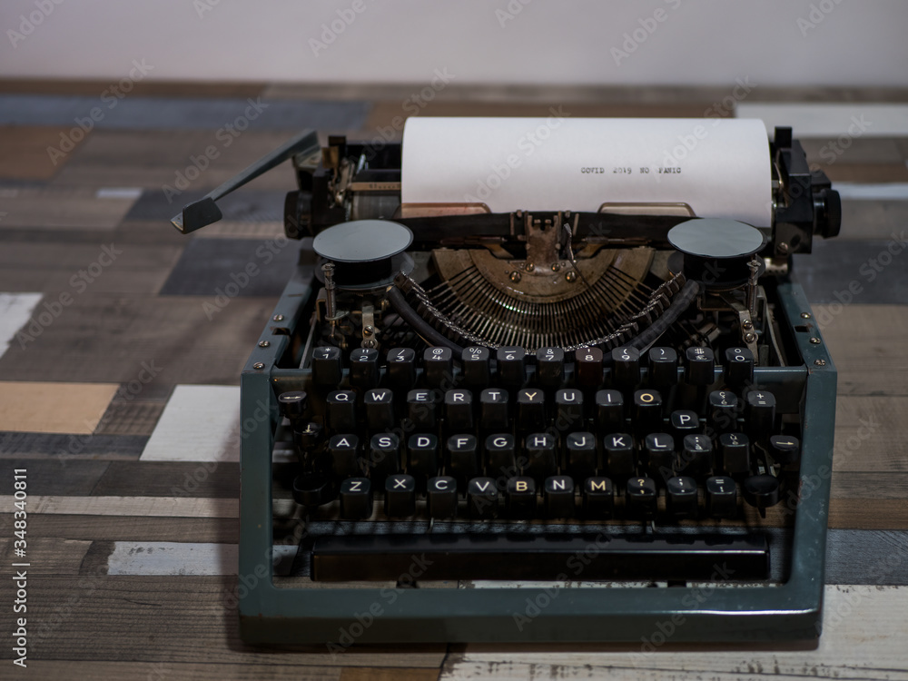 close-up text COVID 2019 NO PANIC. old vintage typewriter with a sheet of white paper close-up text COVID 2019 NO PANIC. old vintage typewriter with a sheet of white paper