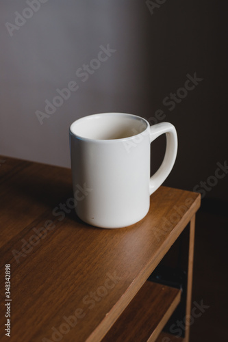 white ceramic mug on a wooden table.