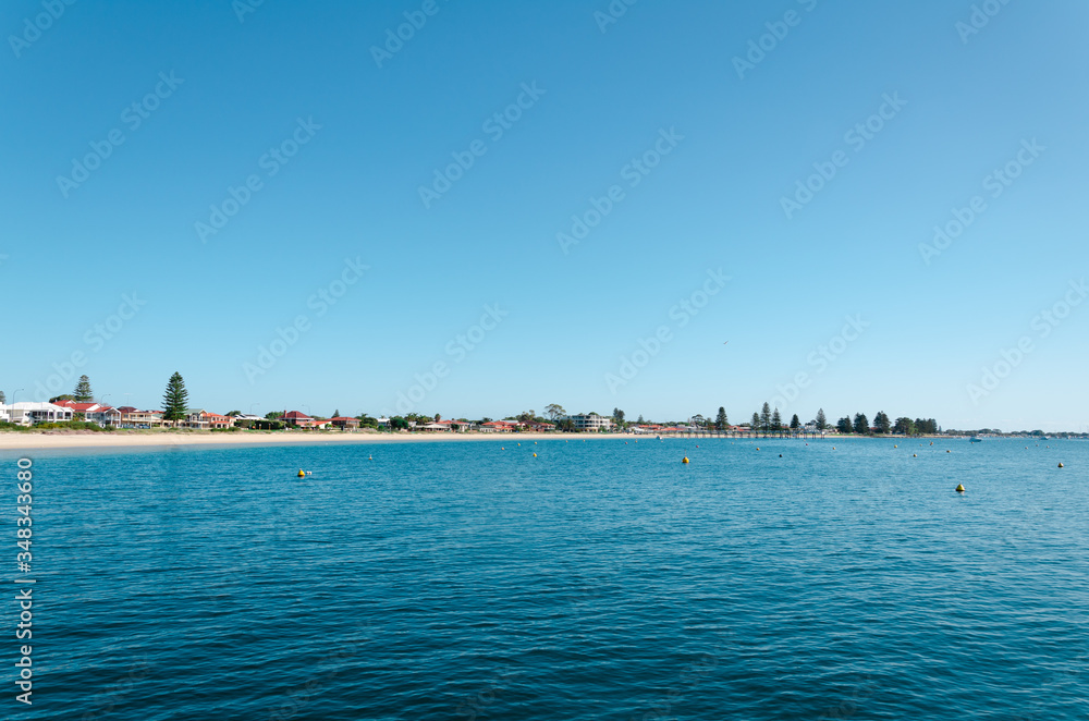 Rockingham Beach on a sunny day with clear blue sky and blue water