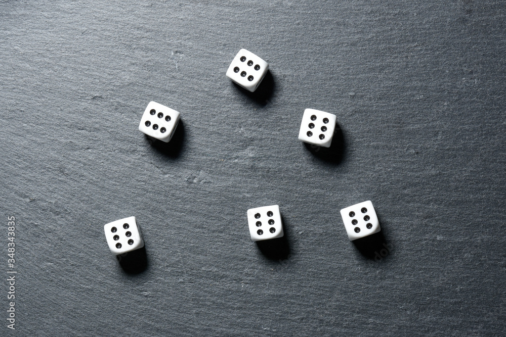 Black stone blackboard with playing dice on Black stone blackboard with playing dice on