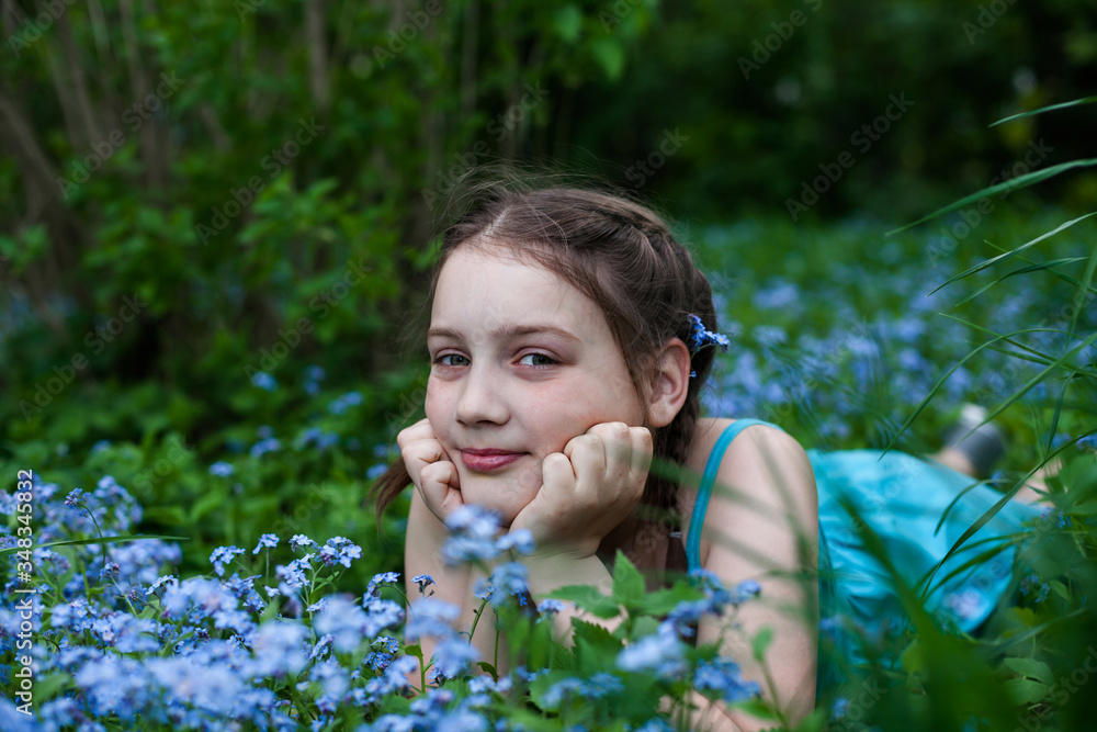 beautiful girl lying in forget me not flowers beautiful girl lying in forget me not flowers