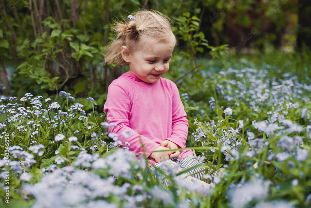 two year old girl with forget-me-nots flowers two year old girl with forget-me-nots flowers