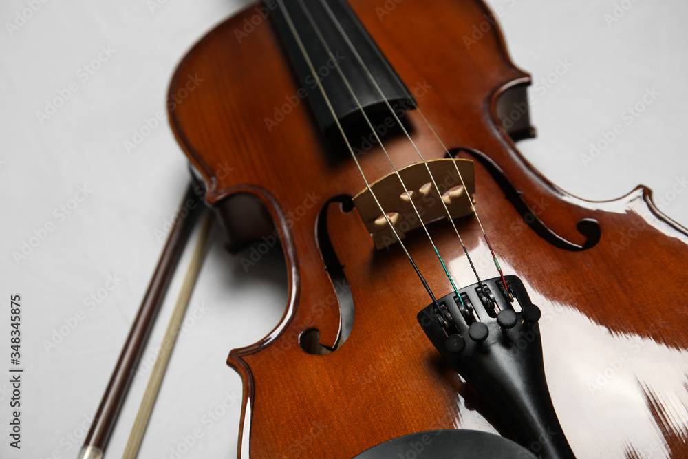 Beautiful violin and bow on grey stone table, closeup Beautiful violin and bow on grey stone table, closeup