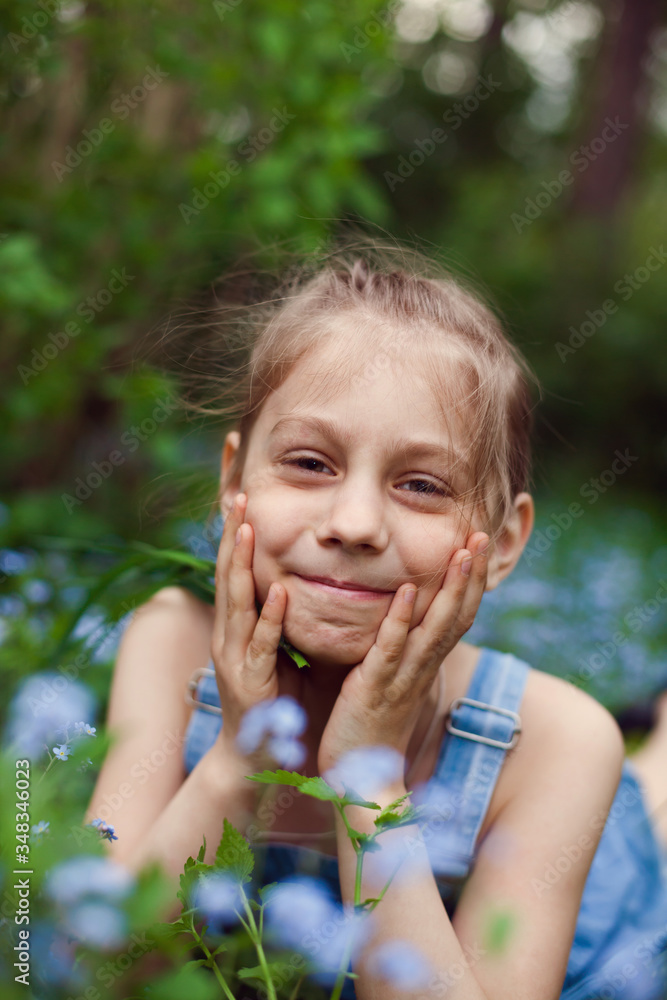 Portrait of little girl with forget-me-nots flowers Portrait of little girl with forget-me-nots flowers