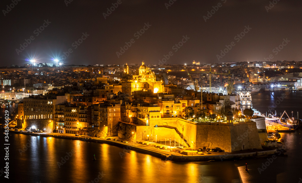 Night view of old architects in Senglea area viewed from Valletta city Malta.