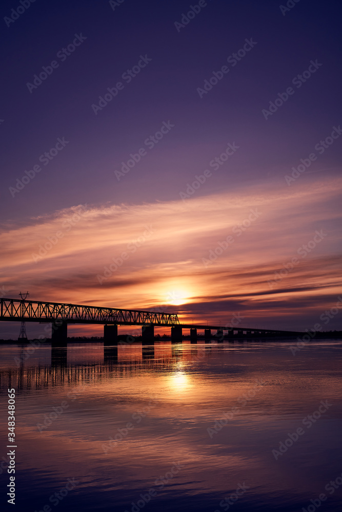 Sunset over bridge through Zeya river