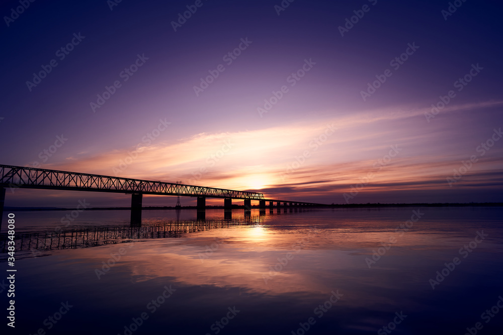 Sunset over bridge through Zeya river
