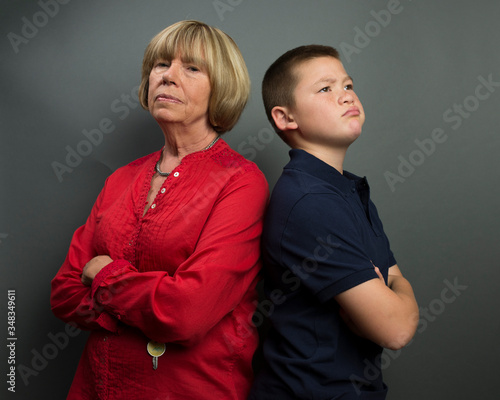 Slika na platnu Mother and son back to back with arms folded in stubborn opposition