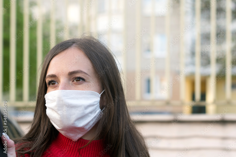 Woman wearing face mask during coronavirus outbreak. Girl in a facemask on a streets Woman wearing face mask during coronavirus outbreak. Girl in a facemask on a streets