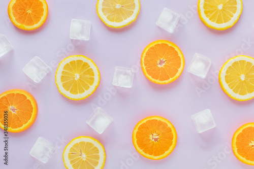 Sliced lemon and orange on a lilac background