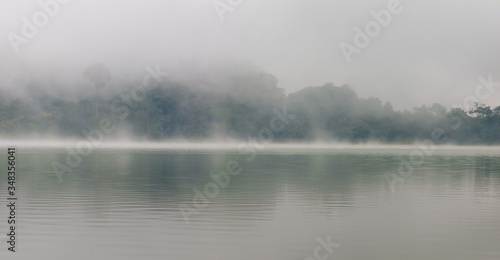 Fog in the middle of a green lake © Nicolas
