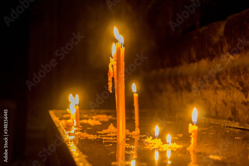 burning candles in the Armenian church in the monastery of Geghard
