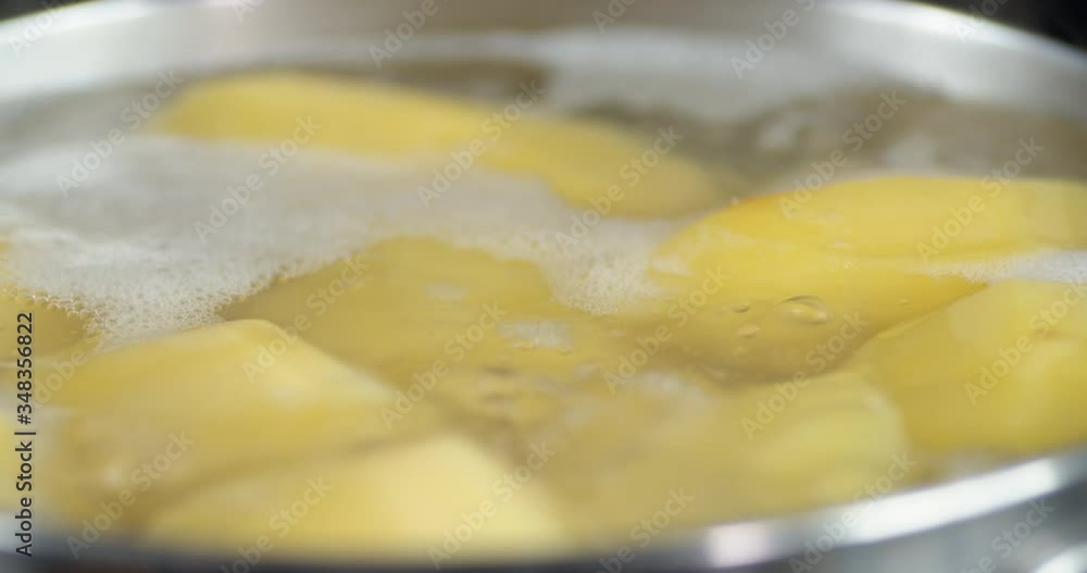 Potatoes cooked in water in a pot with air bubbles. Potatoes cooked in water in a pot with air bubbles.