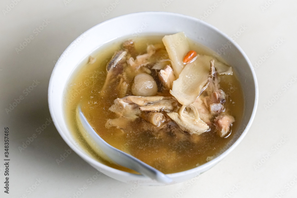 Chinese traditional american ginseng soup with chicken bones served in a bowl. Chinese traditional american ginseng soup with chicken bones served in a bowl.