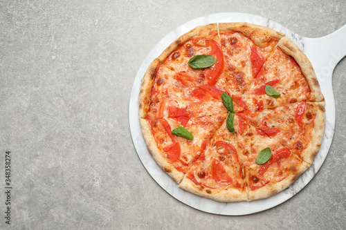 Delicious pizza Margherita on light grey table, top view. Space for text