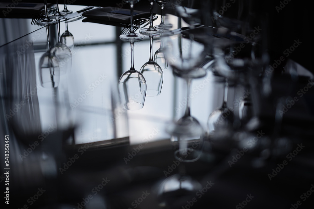 near the window on a dark background is a mirror table with dishes, reflection of glasses in the glass, near the window on a dark background is a mirror table with dishes, reflection of glasses in the glass,