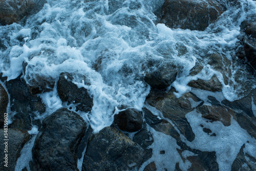 Surf Bubbling over Rocks