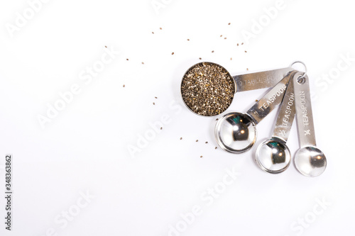 Wallpaper Mural Stainless steel measuring spoons with plant seeds isolated on white background Torontodigital.ca