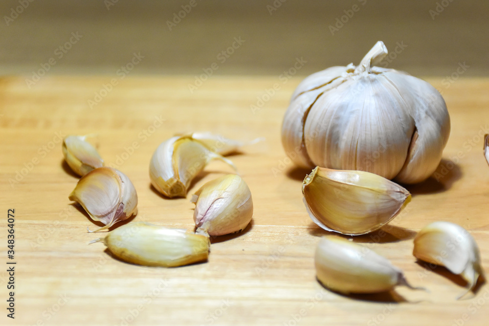 Garlic cloves and bulb group on wooden background. Garlic cloves and bulb group on wooden background.